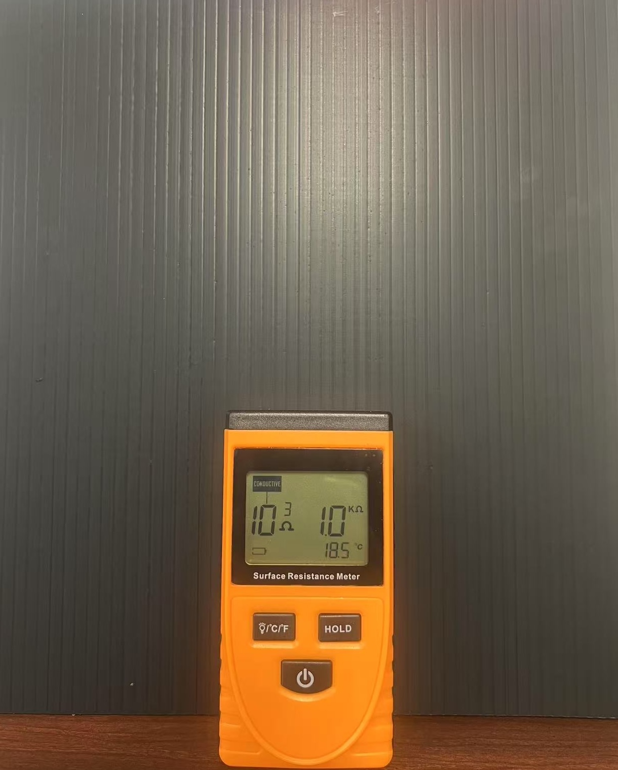 Conductive corrugated plastic sheet with surface resistance meter for ESD-safe applications